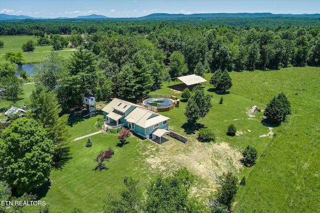 aerial view with a wooded view and a mountain view