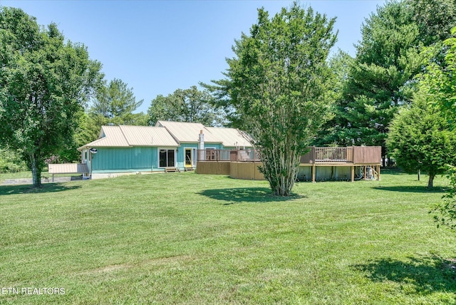 view of front of property with a front lawn and a wooden deck