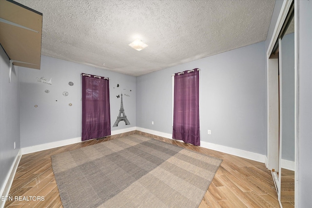 interior space featuring a textured ceiling and hardwood / wood-style floors