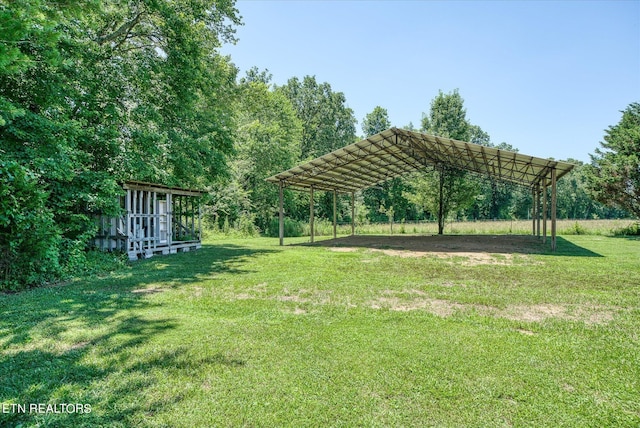surrounding community featuring a detached carport and a lawn