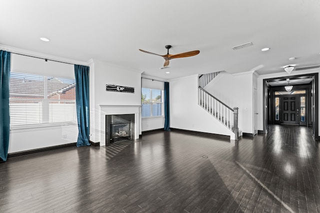 unfurnished living room featuring crown molding, dark wood-type flooring, and ceiling fan