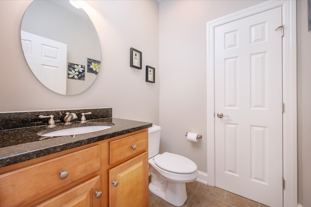 bathroom with vanity, toilet, and tile patterned flooring