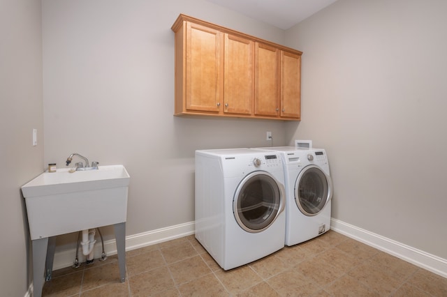 laundry room with cabinets and washer and dryer