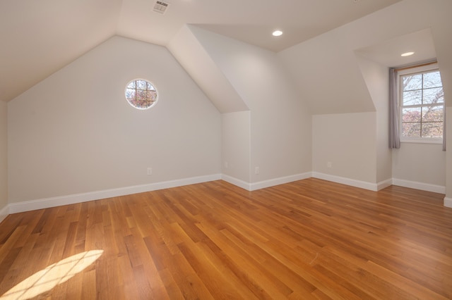 bonus room featuring light hardwood / wood-style flooring and lofted ceiling