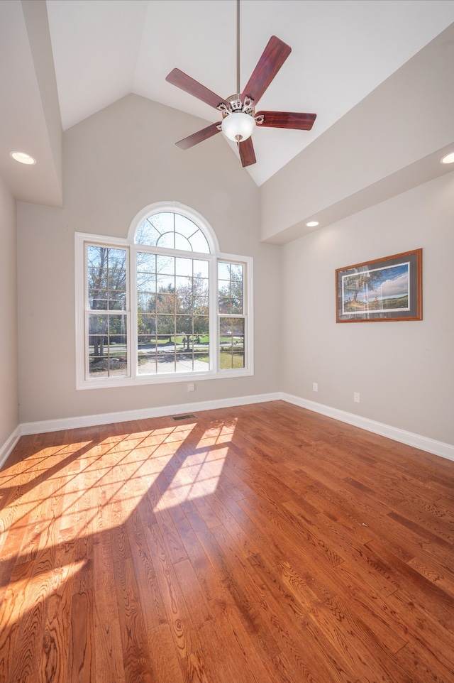 unfurnished room featuring ceiling fan, wood-type flooring, and vaulted ceiling