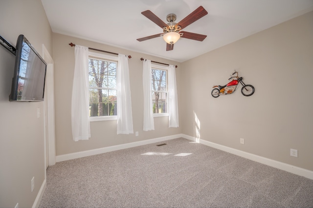 spare room with carpet floors and ceiling fan