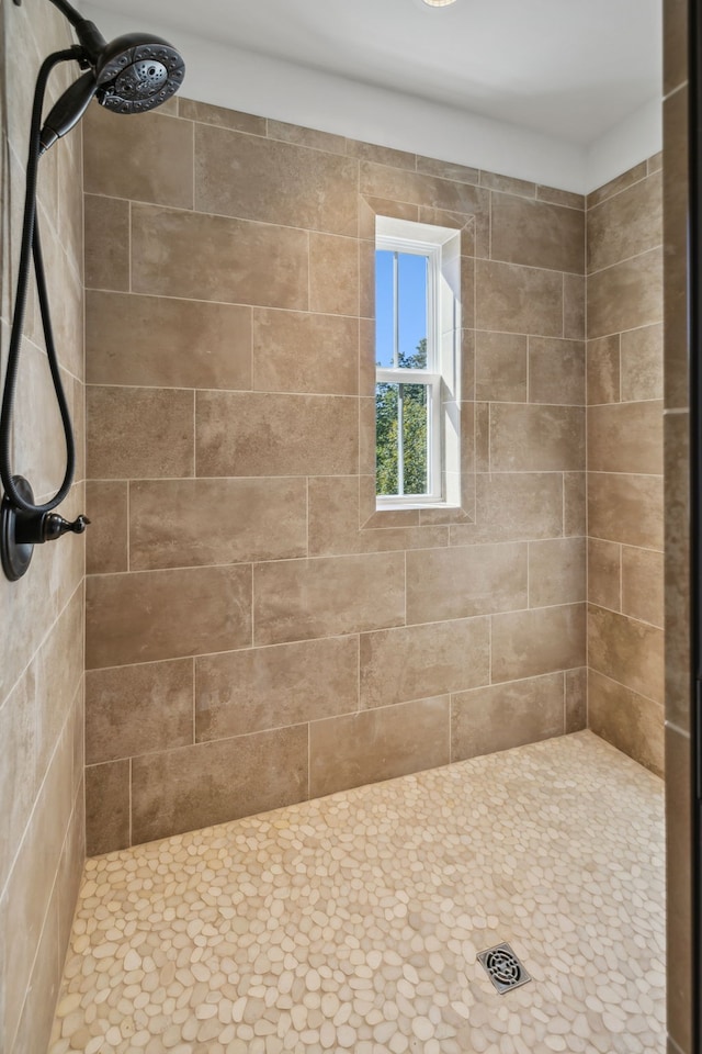 bathroom with tiled shower