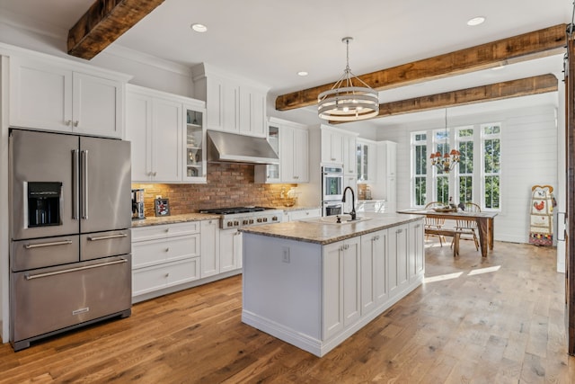 kitchen with hanging light fixtures, white cabinetry, beamed ceiling, a notable chandelier, and stainless steel appliances