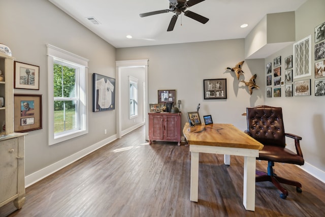 home office with dark wood-type flooring and ceiling fan