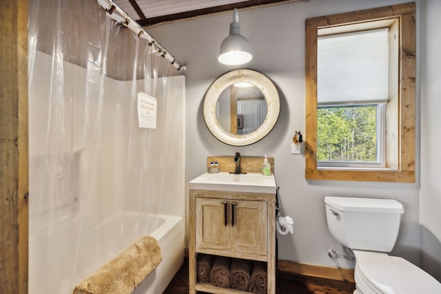 full bathroom with vanity, shower / tub combo with curtain, and toilet