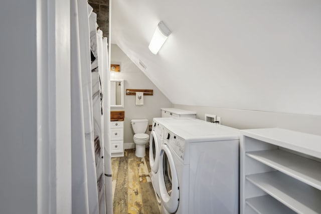 laundry area with independent washer and dryer and wood-type flooring