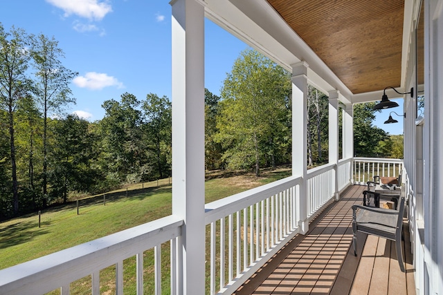 wooden deck featuring a yard and covered porch