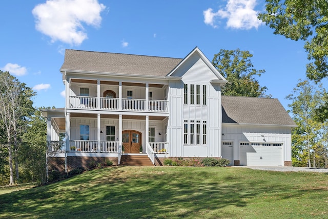 view of front of home with a front lawn, covered porch, a garage, and a balcony