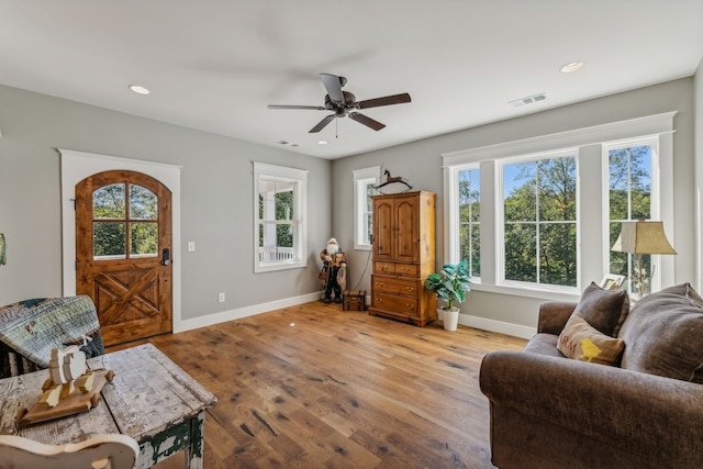 living room with light hardwood / wood-style flooring and ceiling fan