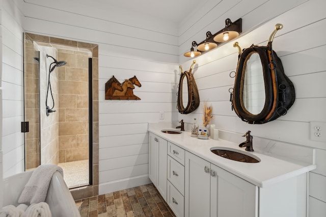 bathroom with a tile shower, wooden walls, and vanity