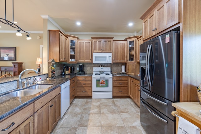 kitchen featuring hanging light fixtures, backsplash, ornamental molding, sink, and white appliances