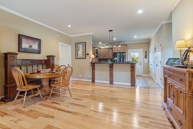 dining room featuring light hardwood / wood-style flooring and ornamental molding