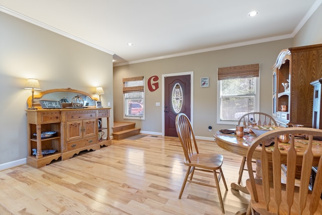 dining area featuring crown molding, light hardwood / wood-style flooring, and a wealth of natural light