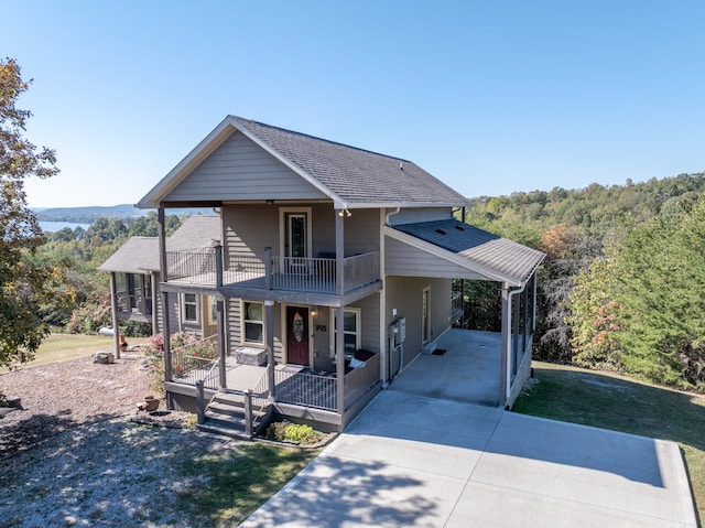 front facade with a porch and a carport