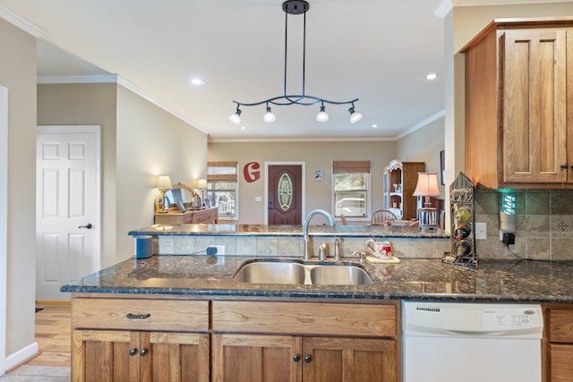 kitchen featuring sink, dishwasher, crown molding, and pendant lighting