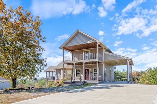 view of front of property with covered porch, a balcony, and a carport