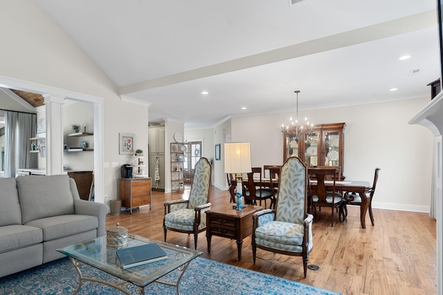 living room featuring light wood-type flooring, ornate columns, vaulted ceiling, ornamental molding, and a chandelier