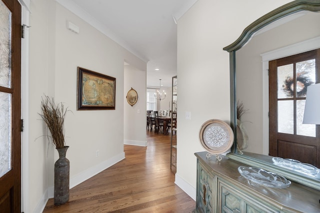 entrance foyer with a notable chandelier and hardwood / wood-style flooring