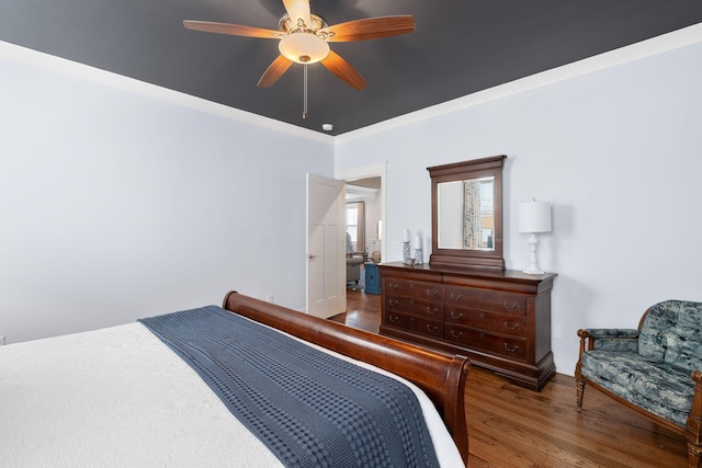 bedroom featuring crown molding, hardwood / wood-style floors, and ceiling fan