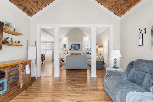 living room with light hardwood / wood-style floors, high vaulted ceiling, and wooden ceiling