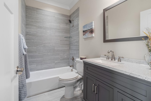 full bathroom with vanity, tiled shower / bath combo, and toilet