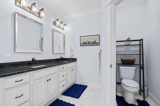 bathroom with vanity, ornamental molding, and toilet