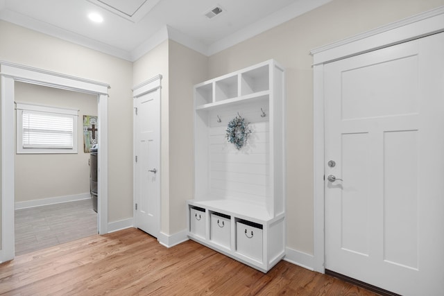 mudroom with ornamental molding and light wood-type flooring