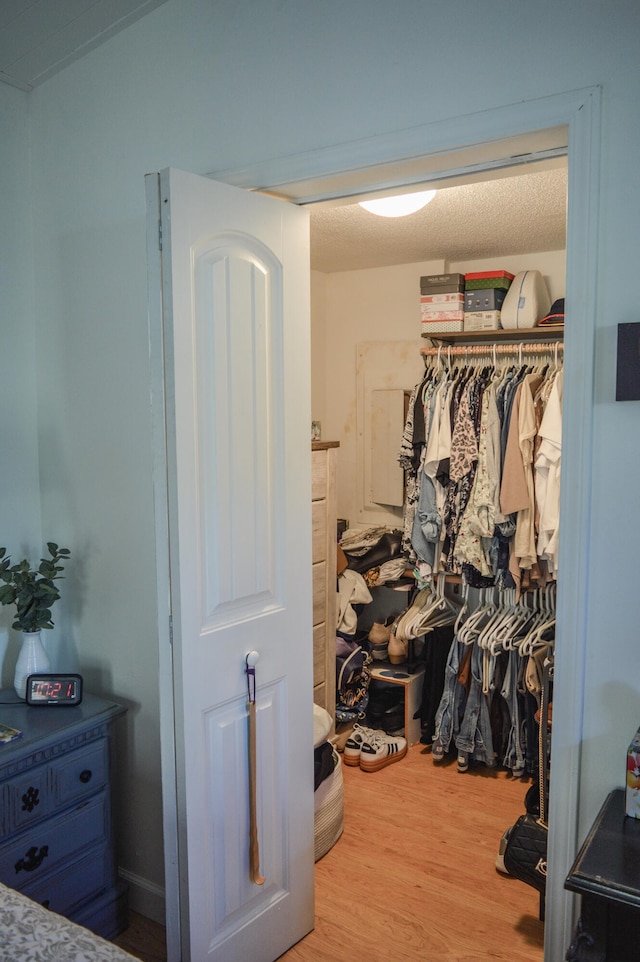 walk in closet featuring hardwood / wood-style flooring