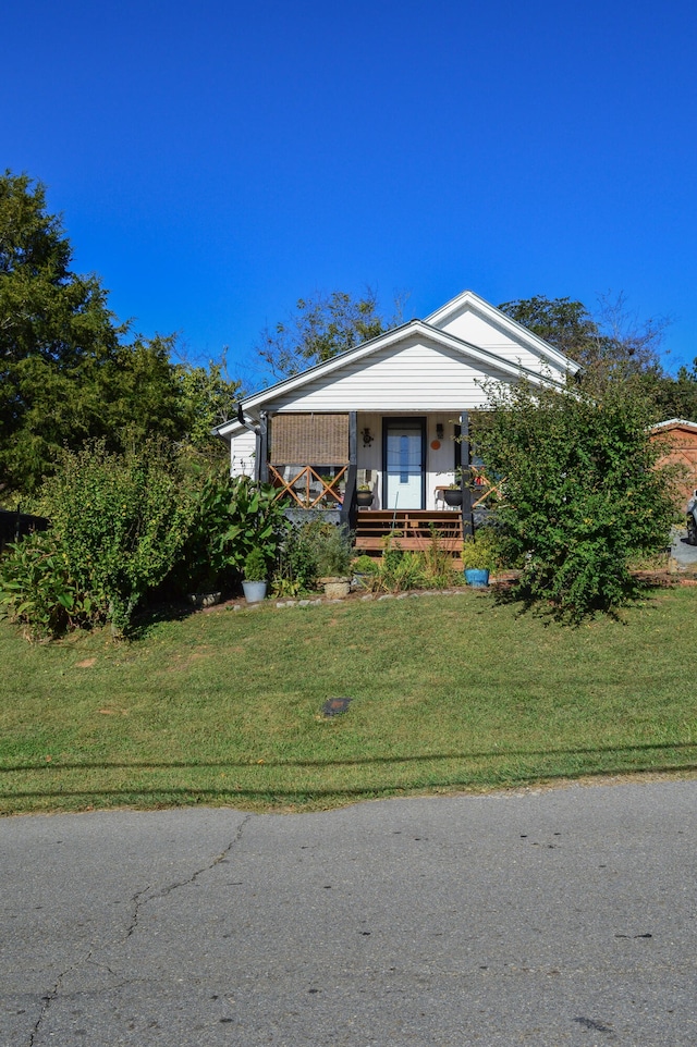 view of front of house with covered porch and a front lawn