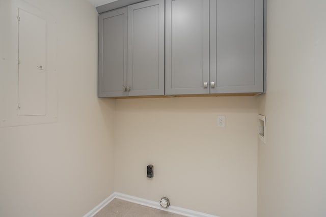 washroom featuring electric panel, washer hookup, and cabinets