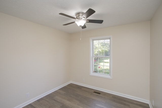 spare room with ceiling fan and dark hardwood / wood-style floors