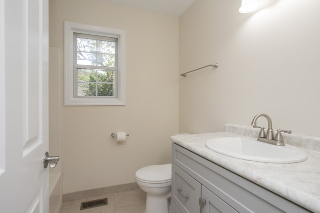 bathroom with vanity, toilet, and tile patterned flooring