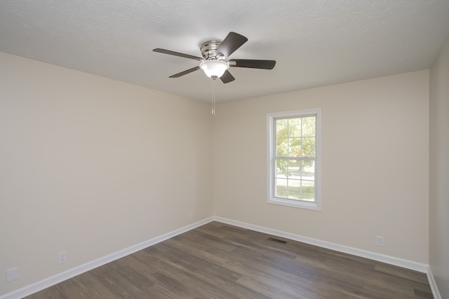 empty room with ceiling fan, a textured ceiling, and dark hardwood / wood-style floors