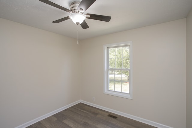 spare room featuring ceiling fan and dark hardwood / wood-style floors