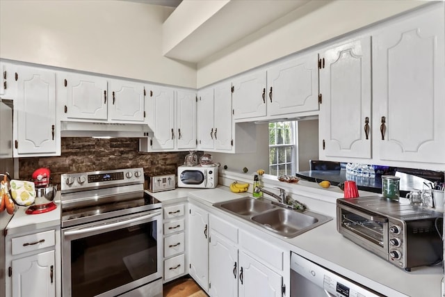 kitchen featuring white cabinetry, appliances with stainless steel finishes, sink, and backsplash