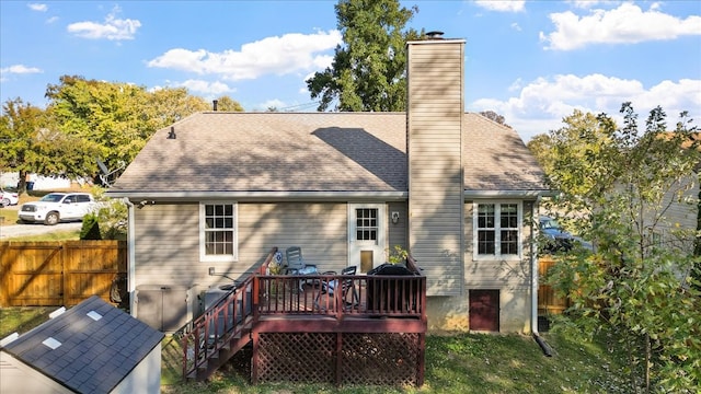 back of property featuring a wooden deck