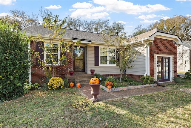 ranch-style house with a front yard and french doors