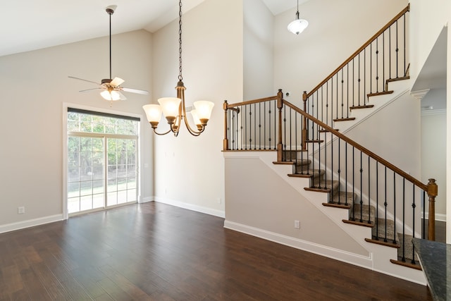 stairway featuring hardwood / wood-style floors, ceiling fan with notable chandelier, and high vaulted ceiling