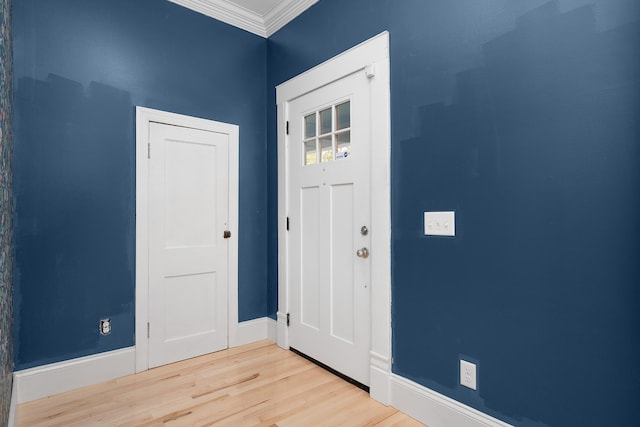 entryway featuring crown molding and light hardwood / wood-style flooring