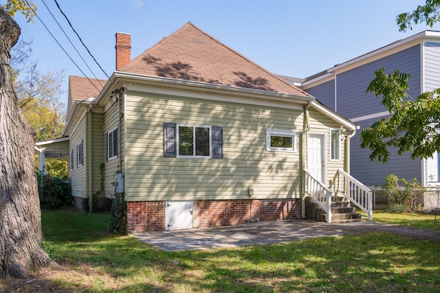 rear view of house with a lawn