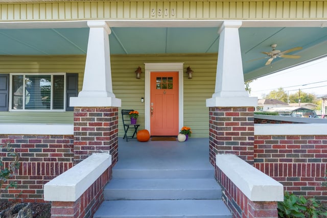 doorway to property featuring a porch and ceiling fan