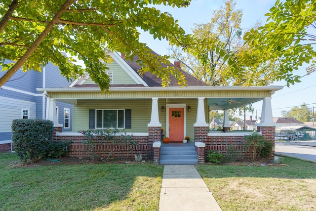 view of front facade featuring covered porch and a front lawn