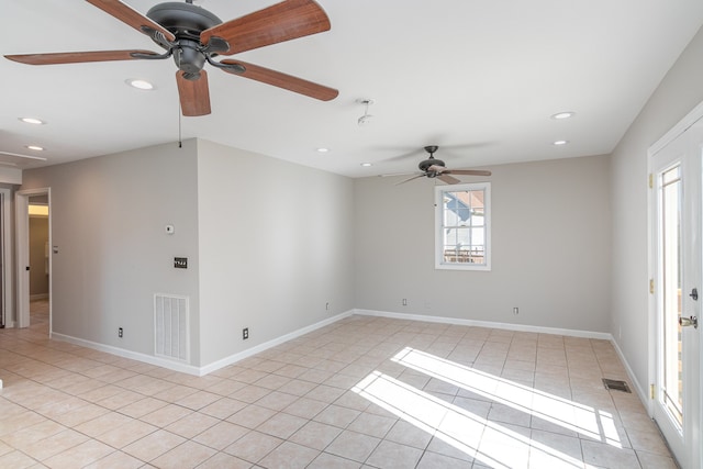 tiled empty room featuring ceiling fan