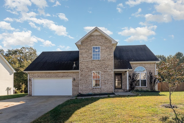 view of front property featuring a front yard and a garage