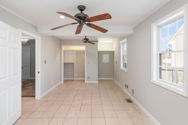 spare room with ornamental molding, ceiling fan, and light tile patterned floors